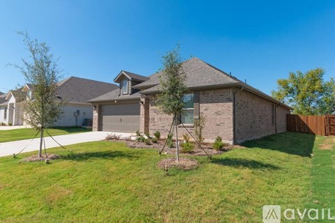 A house with a brown roof and a white garage door.