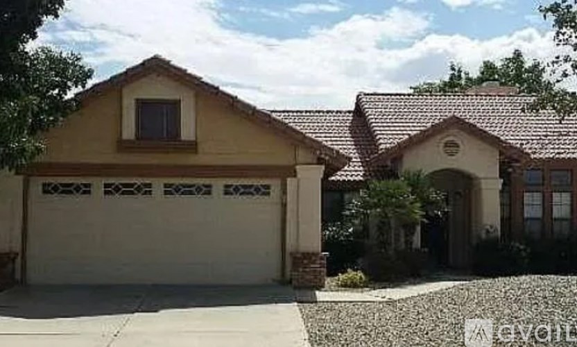 A house with a garage door and a driveway.