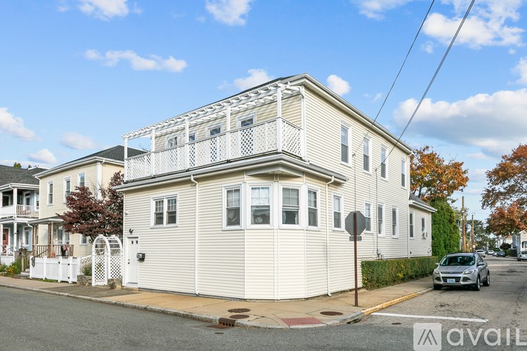 A two-story house with a balcony on the second floor.