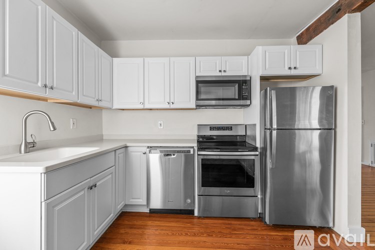 A kitchen with white cabinets and stainless steel appliances.