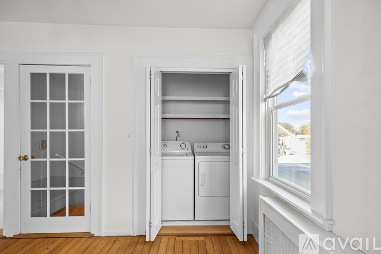 A small laundry room with a washer and dryer.