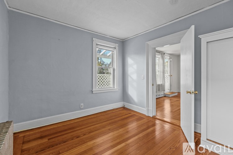 A room with wooden floors and white walls.