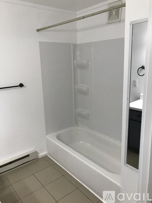 A white bathroom with a walk in shower.
