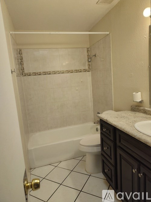 A bathroom with a toilet, sink, and bathtub.
