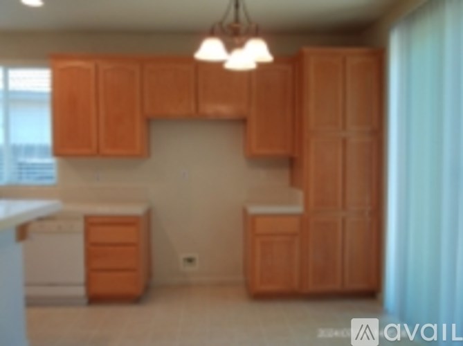 A kitchen with wooden cabinets and a white dishwasher.