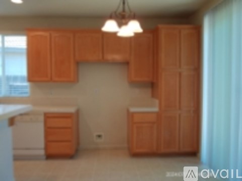 A kitchen with wooden cabinets and a white dishwasher.