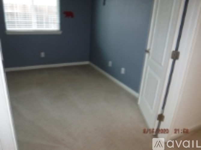 A room with a white door and a window with blinds.