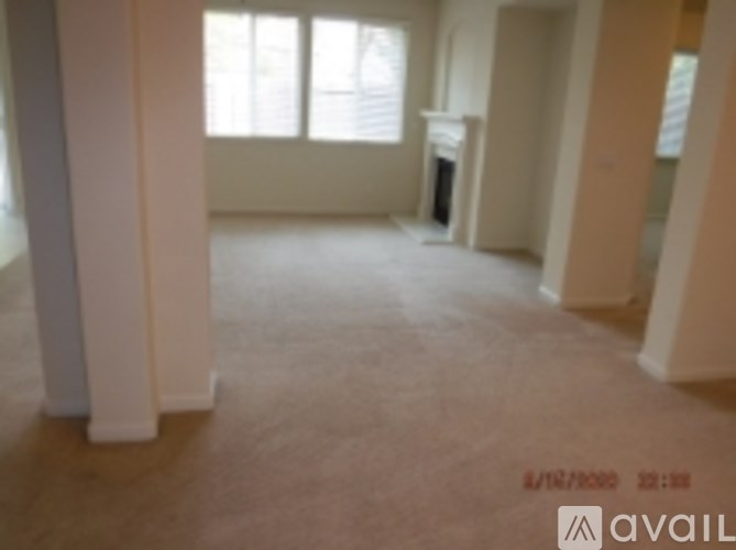 A room with a fireplace and a window.