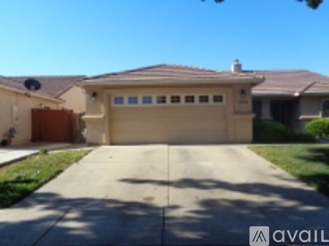 A house with a brown garage door and a driveway in front.