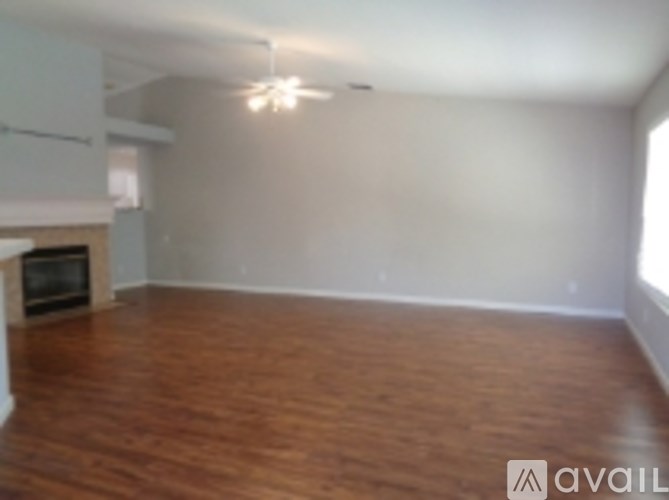 A room with wooden floors and a fireplace.