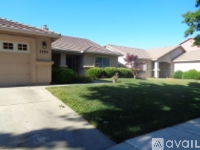 A house with a brown roof and a white garage door.