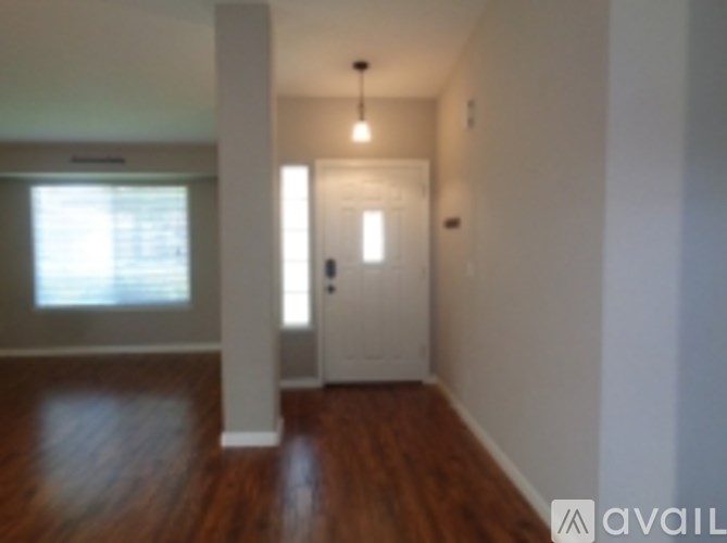 A hallway with a door and a window.