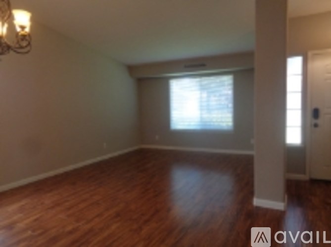 A room with wooden floors and a window.