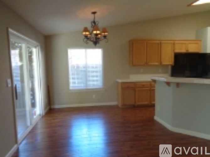 A room with wooden floors and a chandelier.