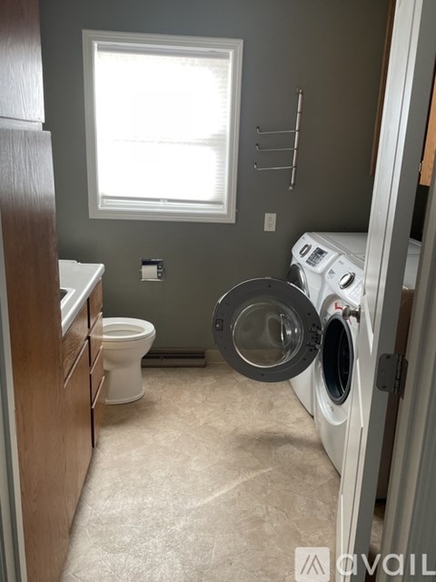 A small laundry room with a washer and dryer.