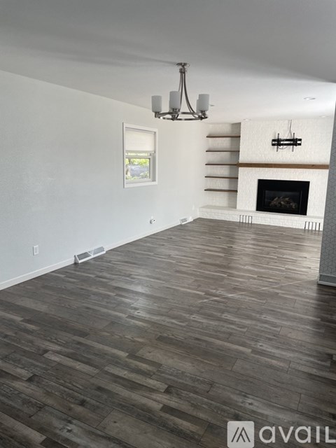 A room with a fireplace and a chandelier.