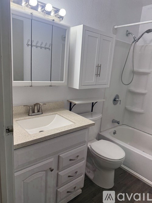 A white bathroom with a sink, toilet, and bathtub.