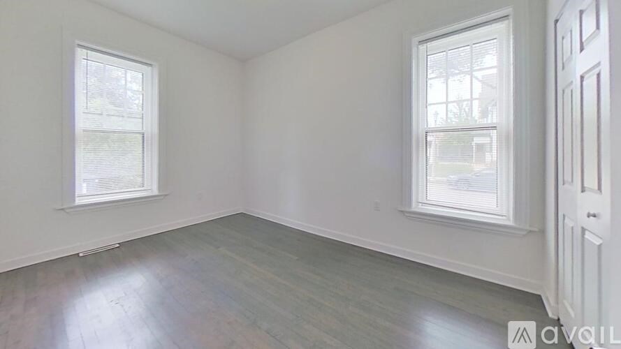 A room with two windows and a door.