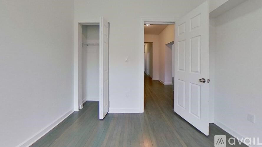 A room with a white door and a white wall.