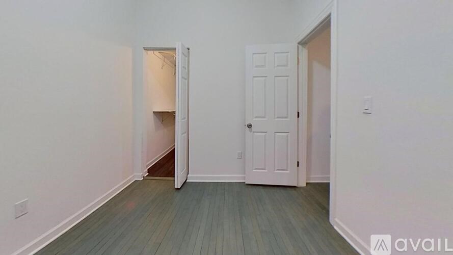 A room with a door and a wall with a window.