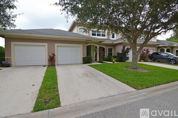 A house with a tree in front of it.