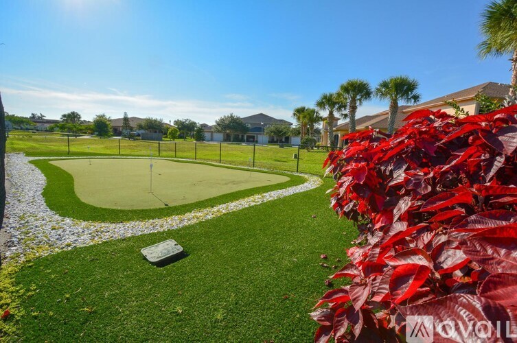 A golf course with a green and a white square in the middle.