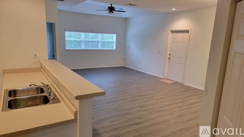 A kitchen with a sink and a window.
