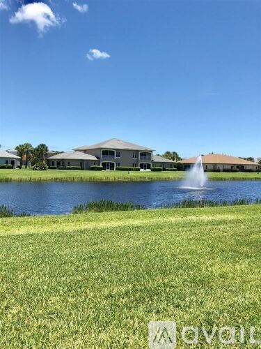 A large house with a fountain in front of it.