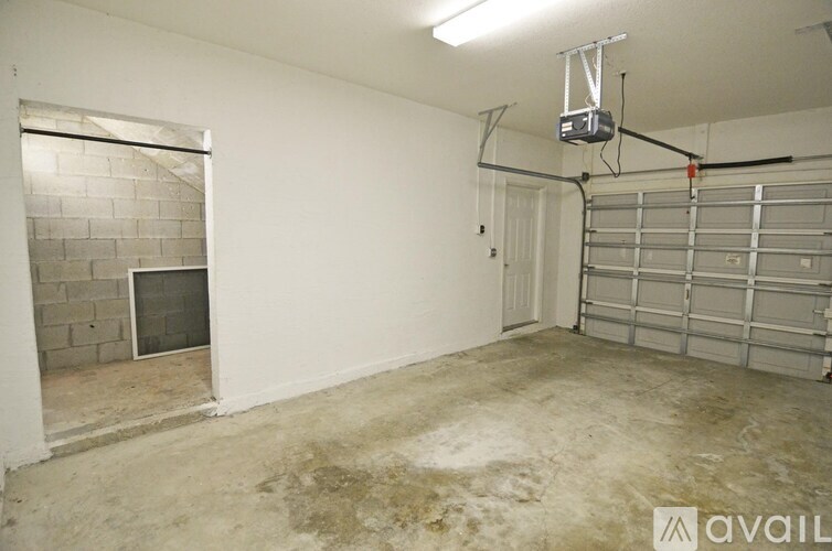 A garage with a concrete floor and a wall made of bricks.
