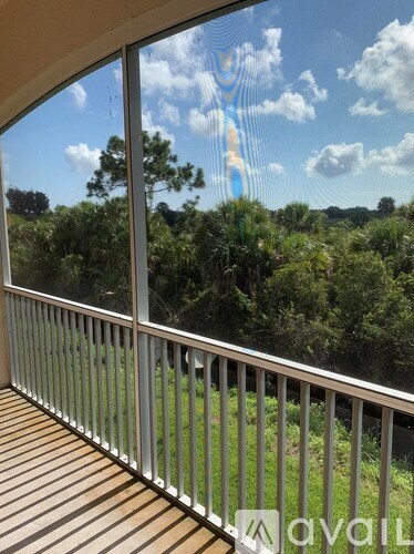 A balcony with a view of a forest.
