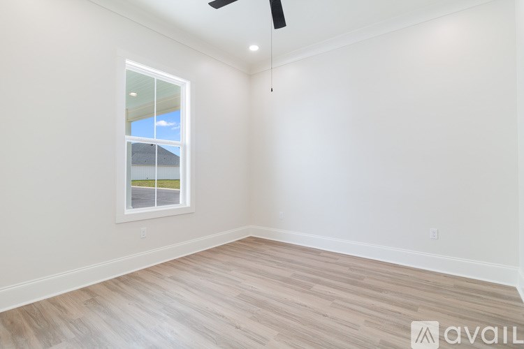 A room with a window and a ceiling fan.