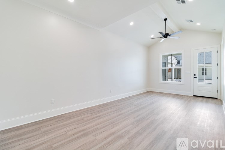 A room with a ceiling fan and lighting fixtures.
