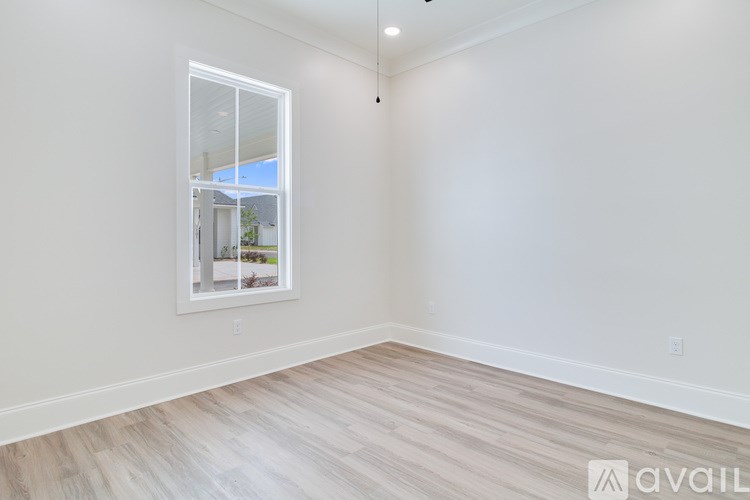 A room with a window showing a house outside.