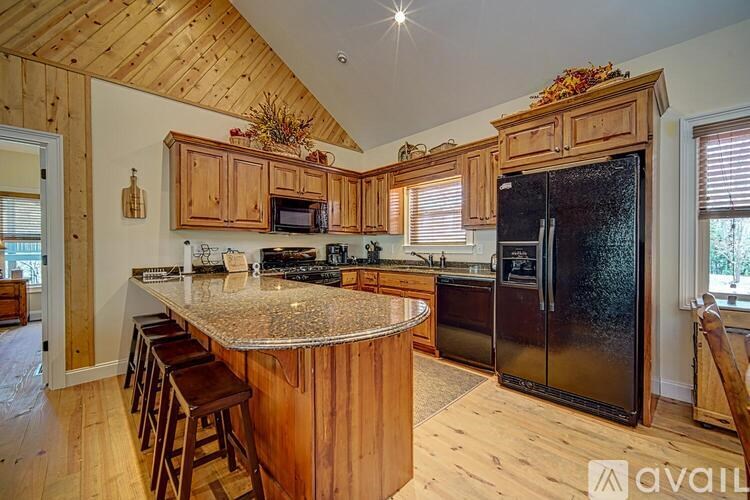 A kitchen with wooden cabinets and a granite countertop.