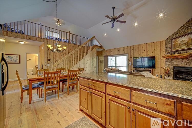 A living room with a staircase and a fireplace.