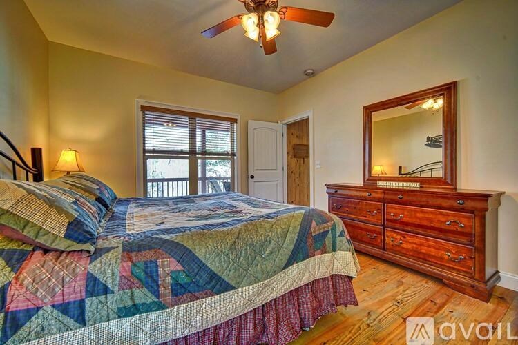 A bedroom with a bed, dresser, and mirror.