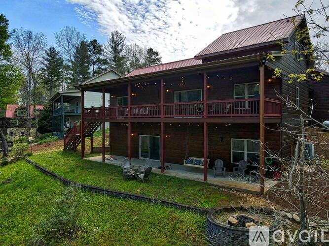 A house with a red roof and a porch.