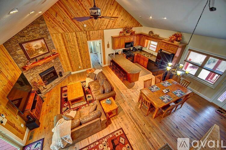 A wooden house interior with a fireplace and a dining table.