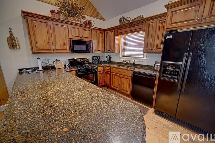 A kitchen with wooden cabinets and granite countertops.