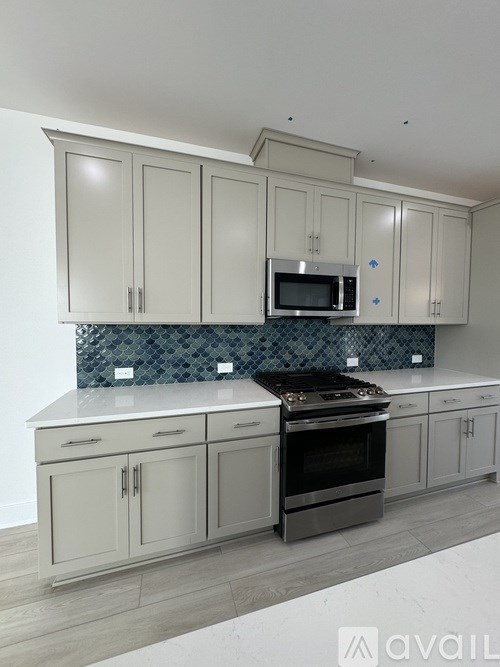A kitchen with a stove top oven and a microwave above the counter.