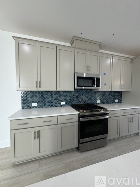 A kitchen with a stove top oven and a microwave above the counter.