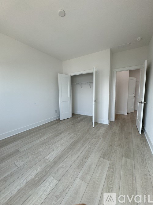 A room with a wooden floor and white walls.