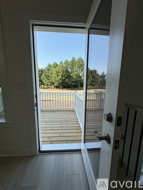 A view of a deck through an open door.