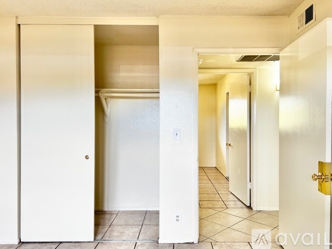A hallway with a white door on the left and a white door on the right.