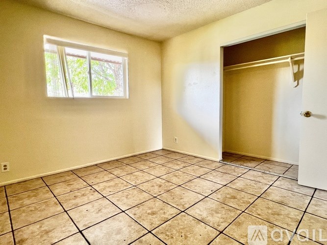 A room with a tiled floor and a window.
