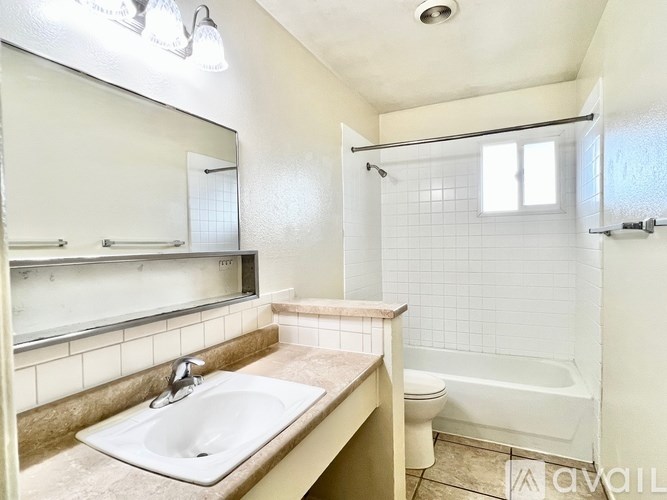 A bathroom with a sink, toilet, and bathtub.