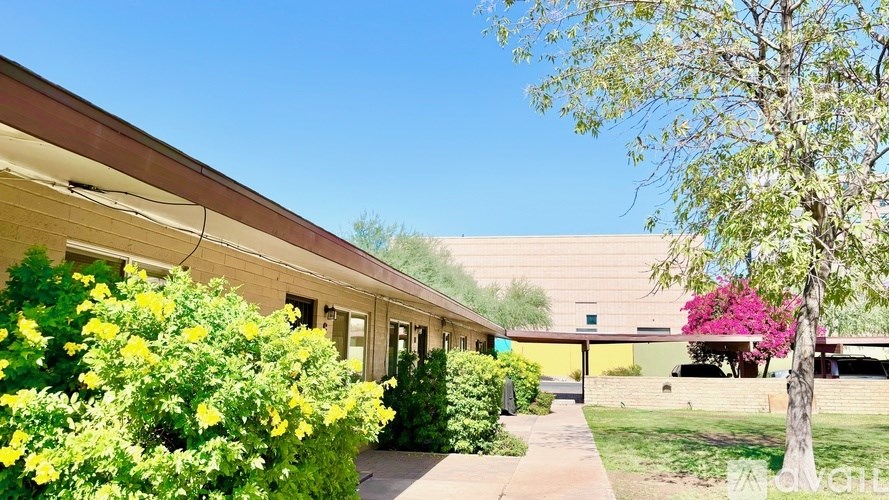 A building with a green lawn in front of it.
