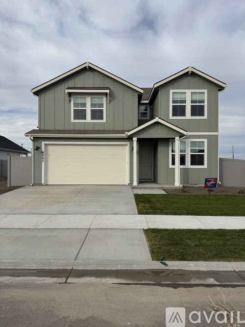 A two-story house with a garage is for sale.