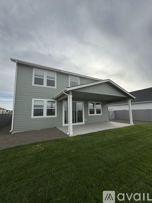 A house with a grey roof and a white door is shown.