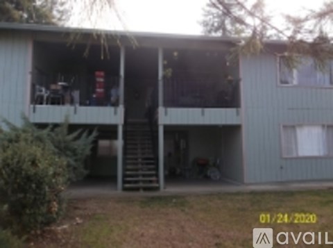 A house with a white porch and a red object on it.